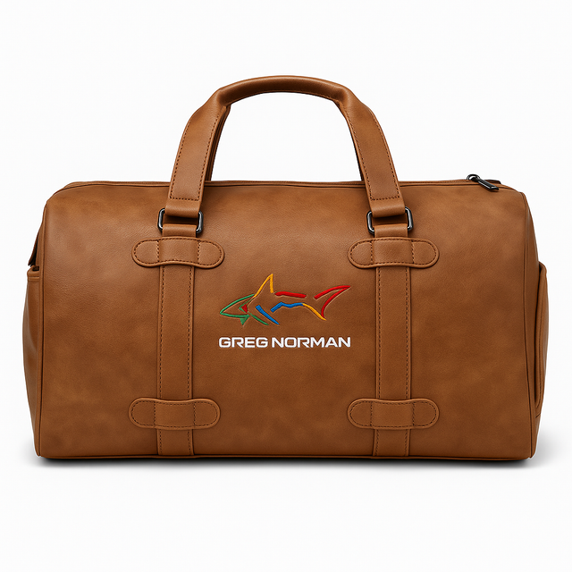 Brown leather Golf duffel bag with Greg Norman logo on a white background