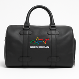 Black duffel bag with colorful shark logo and 'Greg Norman' text on a white background